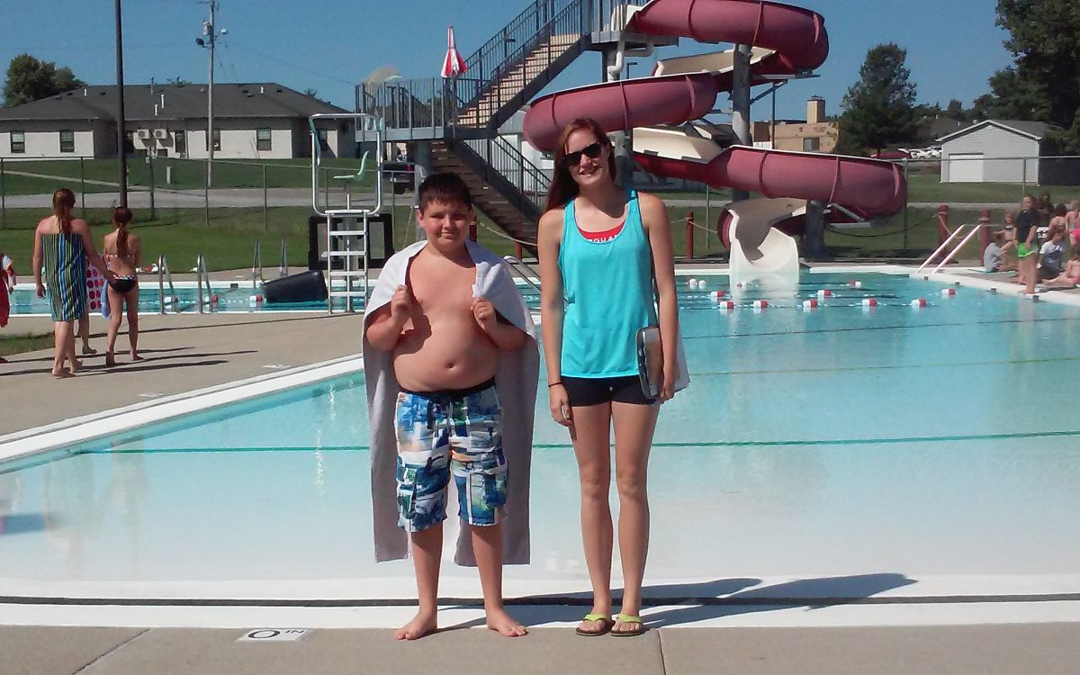 Image of brother-sister at pool with slide