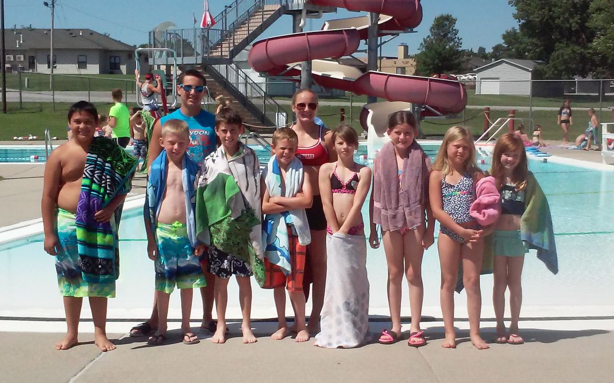 Image of  swim coach and 10 kids